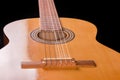 Fragment of traditional wooden acoustic guitar from soundboard side Royalty Free Stock Photo