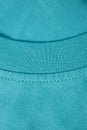 Fragment of a turquoise t-shirt shot close-up