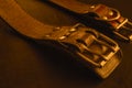 Fragment of two old genuine leather collars on a dark table