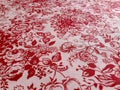 Fragment of vintage textile pattern with red floral ornament useful as background
