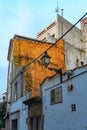 Tossa de Mar, Spain, August 2018. An old lantern among the Mediterranean architecture of the city.