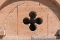 Fragment of the wall of an ancient temple with a cutout in the form of a cross.