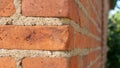 A fragment of a wall made of old red bricks, a conceptual background Royalty Free Stock Photo