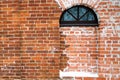Fragment of the wall of an old building with a semicircular window as the basis of the background. Royalty Free Stock Photo