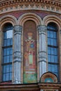 A fragment of the wall of an Orthodox church with the icon of St. Nicholas the Wonderworker painted on it Royalty Free Stock Photo