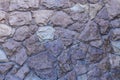 A fragment of a wall of uncrushed rough stone covered with varnish Royalty Free Stock Photo