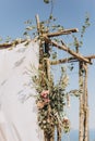 Fragment of a wedding arch for an exit ceremony decorated with flowers.