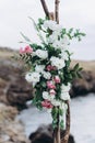 Fragment of a wedding arch for an exit ceremony decorated with white and pink flowers.