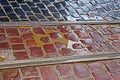 Fragment of wet cobbled road with tram tracks