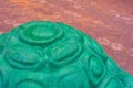 A fragment of wet imitation of concrete cement shell of turtle with green paint Royalty Free Stock Photo