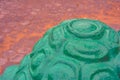 A fragment of wet imitation of concrete cement shell of turtle with green paint Royalty Free Stock Photo