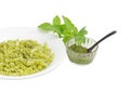 Cooked spiral pasta with pesto and sauce pesto separately