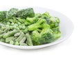 Different frozen green vegetables on white dish closeup Royalty Free Stock Photo