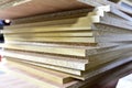 Fragment of a wooden panel made of fiberboard in workshop. Medium Density Fiberboard MDF. Woodworking industry and furniture Royalty Free Stock Photo