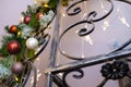 Fragment wrought-iron staircase with the decorated Christmas tree in the interior