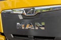 Fragment of the yellow cab of the new MAN TGX GX 18.640 semi-trailer. MAN branding on the radiator protective grille. A