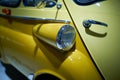 a fragment of a yellow vintage car stands in the museum