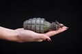 fragmentation grenade in girl hand