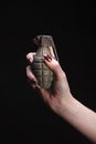 fragmentation grenade in woman hand