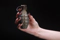 fragmentation grenade in woman hand