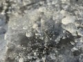 Fragments of beautiful broken ice lay on the ground and sparkle in the sun Royalty Free Stock Photo