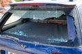 Rear window of a car smashed, vandalised.