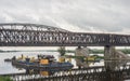 Fragments of spans of old steel bridge at construction site of a new bridge