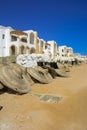 Fragments of an unfinished construction and abandoned hotel on the Red Sea on a background of yellow sand and blue sky. Royalty Free Stock Photo
