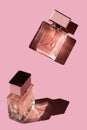 Fragnance parfume. Bottles of pink woman perfume on a pastel pink background,. Mockup of fragrance perfume. Trendy sunlight