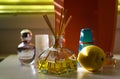 Fragrance diffusor glass with reed sticks between perfume flacons giving natural scent of lemon