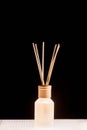 Fragrance for home. Aroma diffuser glass jar with aromatic liquid and bamboo sticks