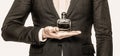 Fragrance smell. Men perfumes. Fashion cologne bottle. Man holding up bottle of perfume. Men perfume in the hand on suit Royalty Free Stock Photo