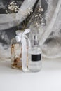 Fragrance spray in a transparent plastic bottle with black empty tag