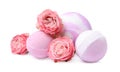 Fragrant bath bombs and rose flowers on white background