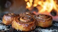Fragrant cinnamon rolls freshly baked in a woodfired oven are coated in a gooey glaze that melts in your mouth. The Royalty Free Stock Photo