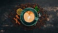 A fragrant cup of coffee Cappuccino on a black wooden background. Royalty Free Stock Photo