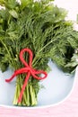 Fragrant dill and parsley leaves lie on the plate