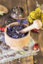 Fragrant dried healing herbs for therapy and spicy spices. On the table in a mortar are purple basil, tansy, pepper, chili and Royalty Free Stock Photo