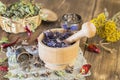 Fragrant dried healing herbs for therapy and spicy spices. On the table in a mortar are purple basil, tansy, pepper, chili and Royalty Free Stock Photo