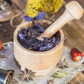 Fragrant dried healing herbs for therapy and spicy spices. On the table in a mortar are purple basil, tansy, pepper, chili and Royalty Free Stock Photo