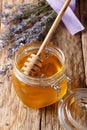 Fragrant fresh lavender honey in a glass jar close-up. vertical