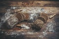 Fragrant, fresh and tasty black bread with spikelets and grains on a vintage surface