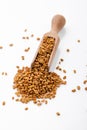 Fragrant grains of fenugreek on a white background