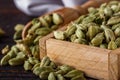 Fragrant green cardamom on a wooden rustic background