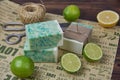 Fragrant handmade soap, scissors and rope, lemon and lime, lie on the packaging paper with the inscription love