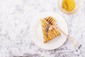 Fragrant homemade honey cake with nuts and lavender on gray concrete background fresh in the horizontal version