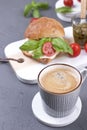 A fragrant morning coffee and a sandwich with mozzarella and basil for breakfast. Tasty and healthy food. Italian lunch. Copy Royalty Free Stock Photo