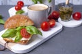 Fragrant morning coffee and a sandwich with mozzarella, pesto sauce with basil for breakfast. Tasty and healthy food. Italian Royalty Free Stock Photo