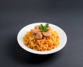 Fragrant Pilau. Pilaf, fried rice with meat and vegetables on a white plate. Isolated on gray Royalty Free Stock Photo