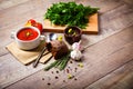 A fragrant red borscht in a white plate with a lots of vegetables on wooden background. Food concept.